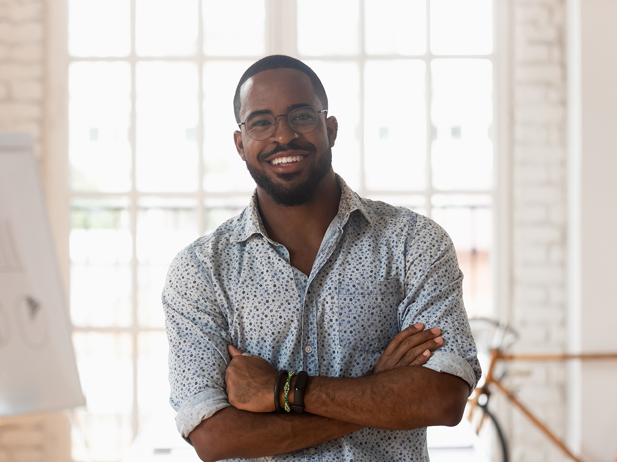 Smiling,Confident,African,American,Young,Businessman,Standing,With,Folded,Hands,