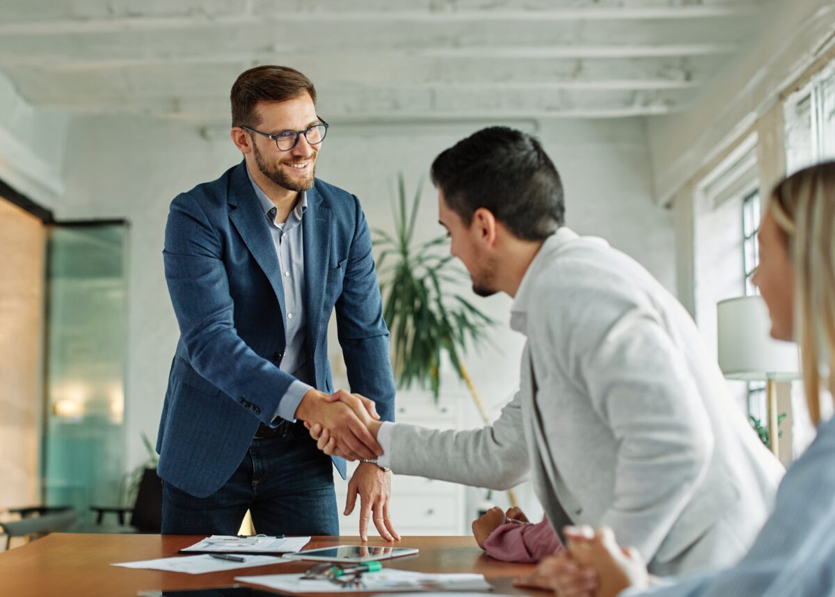 Portrait,Of,A,Young,Businessman,Businessmen,Shaking,Hands,Introducing,Each